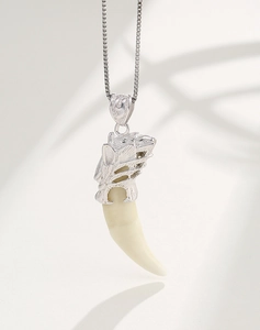 Detail of S925 sterling silver animal head pendant with tooth inlay and hallmark
