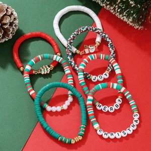 Detailed view of red and green Christmas clay bead bracelets with JOY and MERRY holiday charms