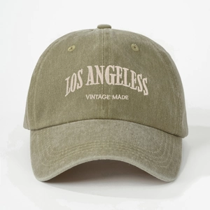 Detailed close-up of Los Angeles vintage embroidery on washed olive green cotton baseball cap