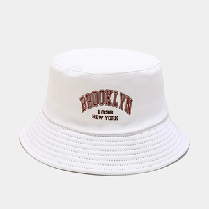 Detailed close-up of embroidered Brooklyn 1898 lettering on white cotton bucket hat