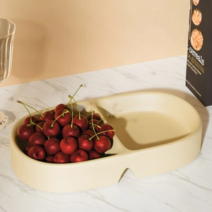 Close-up of a dual-compartment oval silicone tray mold used for elegant fruit storage
