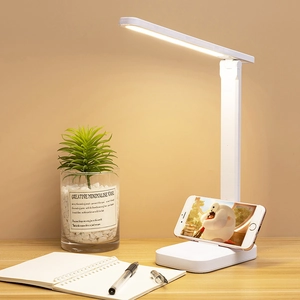 Foldable white LED desk lamp with adjustable arm and built-in mobile phone holder base