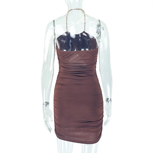 Detail of brown ruched bodycon dress with gold chain halter strap and backless design