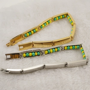Chic 18K gold and silver stainless steel bead bracelets on a white plush background