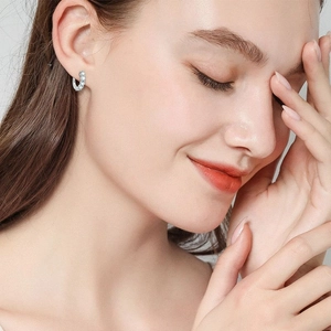 Elegant S925 sterling silver hoop earrings with pavé moissanite stones on female model