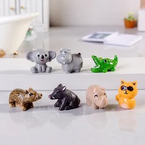 Group shot of colorful resin animal miniatures including hippo, crocodile and raccoon