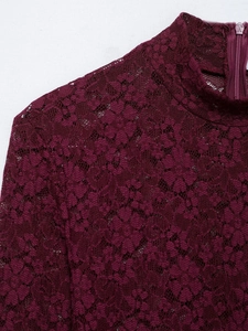 Macro shot of burgundy lace high collar and back zipper detail of the long dress