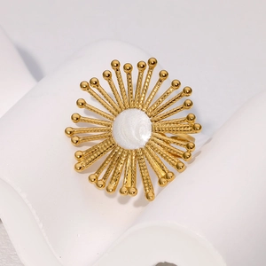 Vintage gold sunflower open ring with white enamel center on a clean white display stand