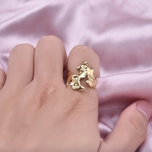 Irregular 18K gold plated stainless steel ring with abstract lava texture worn by a model