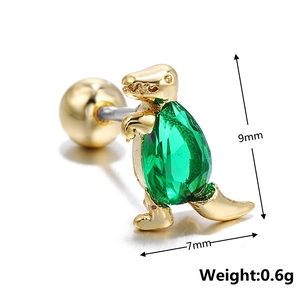 Macro shot of gold dinosaur stud earring with green gemstone inlay showing 9mm height detail