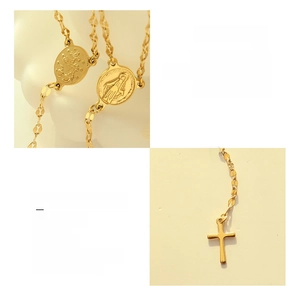 Detail view of 18K gold plated titanium steel necklace with cross and medallion pendants