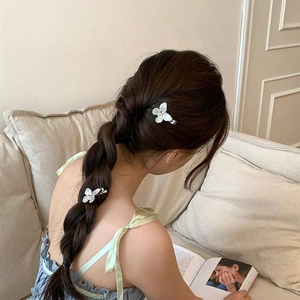 Silver butterfly hair clips with shimmering crystals worn on model side hair styling