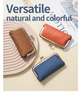 Detailed flat lay of pebble leather coin purses in brown, orange, and blue with gold clasps