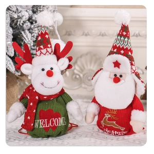 Detail of Christmas reindeer and Santa Claus knitted plush gift bags with drawstrings
