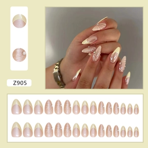 French almond press-on nails with 3D shell patterns and rhinestones in cream yellow