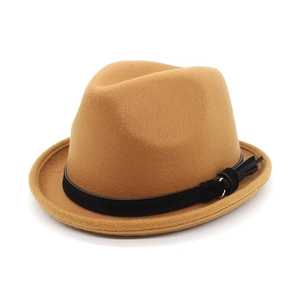 Detail shot of camel wool fedora hat featuring a black band and metallic buckle