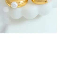 Detailed macro view of 18k gold plated ring with a white pearl and minimalist design