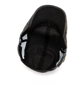Close-up of the internal lining and metal adjustment buckle on the washed denim beret