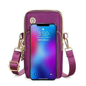 Vertical nylon crossbody phone bag in magenta with dual zippers and earphone hole