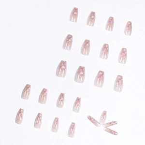 Nude pink gradient press-on nails in long coffin shape with delicate heart patterns