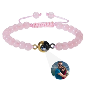 Detailed view of pink quartz bead bracelet with photo projection stone and braided cord