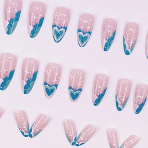 Medium almond press-on nails with blue hearts and wave patterns on pink base