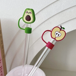 Detail of fruit-themed dust caps for straws featuring avocado and apple designs