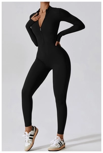 Macro detail of high-stretch matte black fabric and zipper neckline on athletic jumpsuit