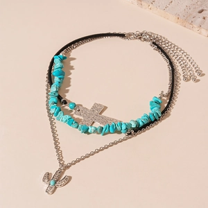Three-layer bohemian necklace featuring turquoise stones, silver cross, and cactus charms