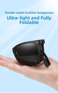 Close-up of portable black folding sunglasses showing the ultra-lightweight frame