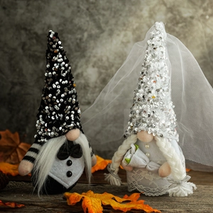 Romantic bride and groom wedding gnomes set with sequins and lace on wooden table