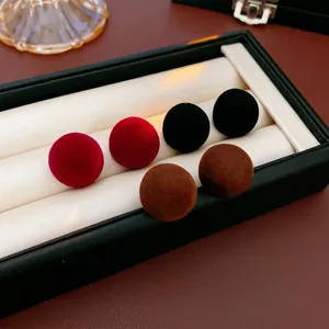 Minimalist flocking round stud earrings set in deep red, black and brown matte velvet