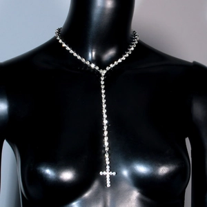 Detailed view of silver cross pendant necklace with sparkling rhinestones on black mannequin