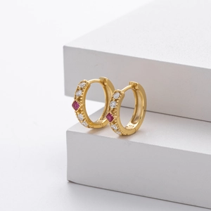 Close-up of S925 sterling silver gold earrings with red and white zircon accents