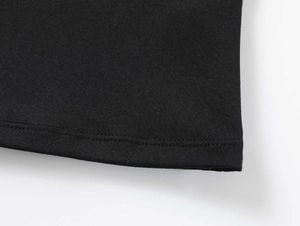 Macro shot of double-needle hem stitching on black stretchy athletic knit fabric