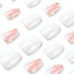 Short round press-on nails featuring white gloss finish and pink floral glitter designs