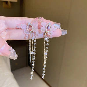 Detail of pink butterfly earrings with long tassels, zircon crystals and pearl accents