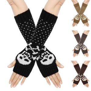 Detail of knitted skull pattern arm warmers in black, gray, and brown color options