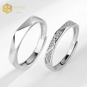 Close-up of adjustable S925 sterling silver couple rings with geometric faceted textures