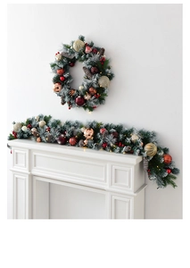 Close-up of a 135cm lush Christmas garland with red and gold ornaments on a mantel