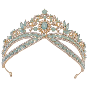 Close-up of golden bridal tiara featuring mint green crystals and sparkling rhinestones
