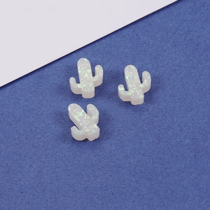 Three opal cactus charms with iridescent sequins on a dark blue background