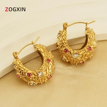 Detail of 18K gold-plated hollow hoop earrings with textured finish and zircon inlays