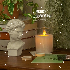 Luminous transparent glass Christmas candle lamp with warm yellow LED flame and snow effect