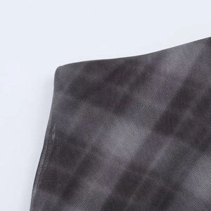Detail of dark grey mesh fabric with tie-dye pattern and breathable textile texture