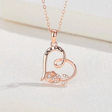 Macro detail of rose gold heart pendant with rose floral and MAMA engraving