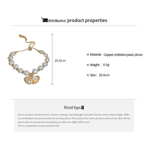 Detail view of adjustable pearl bracelet with zircon shell charm and sizing scale