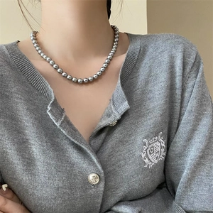 Elegant French vintage grey pearl necklace for women worn by a model in natural light
