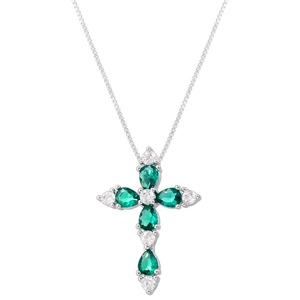 Macro view of cross pendant with pear-cut green gemstones and white cubic zirconia crystals