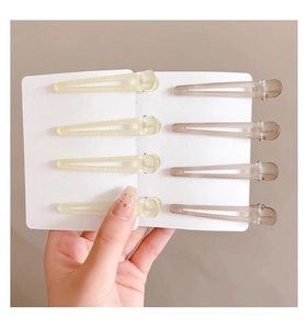 Detail of 8-pack jelly frosted acrylic hair clips in light yellow and brown colors